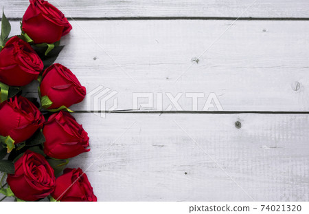 Beautiful red roses on white wood background with copy space for text for love, wedding and valentine day Beautiful red roses on white wood background with copy space for text for love, wedding and valentine day 74021320