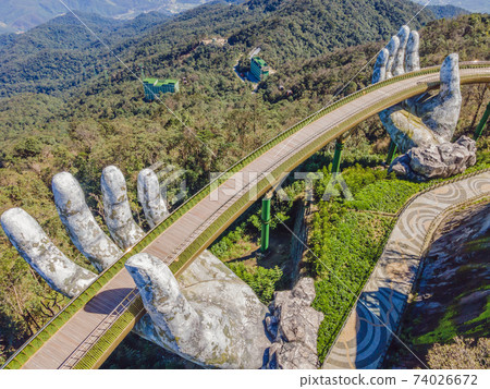 Famous tourist attraction - Golden bridge at the top of the Ba Na Hills, Vietnam 74026672