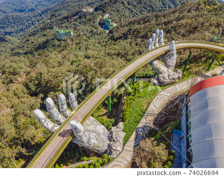 Famous tourist attraction - Golden bridge at the top of the Ba Na Hills, Vietnam Famous tourist attraction - Golden bridge at the top of the Ba Na Hills, Vietnam 74026694
