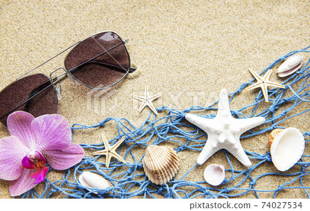 Blue Fishing net on a beach sand, travel concept Blue Fishing net on a beach sand, travel concept 74027534