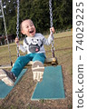 3-year-old boy playing on a swing 74029225