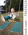 3-year-old boy playing on a swing 74029228