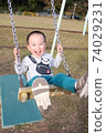 3-year-old boy playing on a swing 74029231