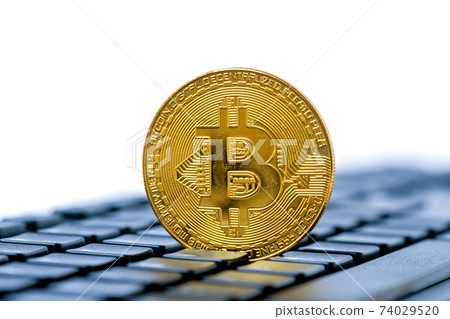 Golden bitcoin on keyboard, copy space 74029520