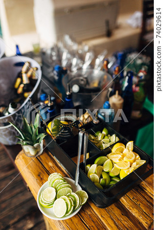 Slices and lemon and lime circles on the bar. Slices and lemon and lime circles on the bar. 74029614