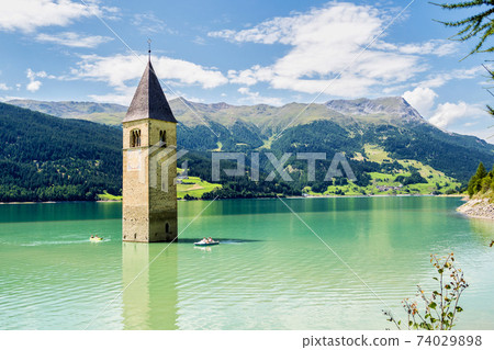 Church in the water at Lake Reschen in Tyrol in north Italy Church in the water at Lake Reschen in Tyrol in north Italy 74029898