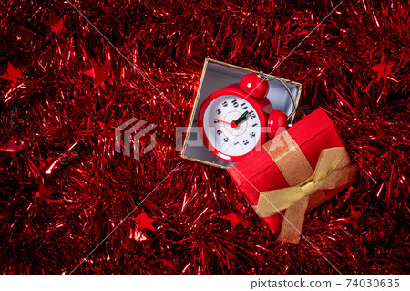 Christmas and New Year holiday composition with gift box and alarm clock Christmas and New Year holiday composition with gift box and alarm clock 74030635
