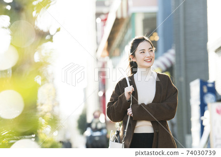 A young lady walking in the city A young lady walking in the city 74030739