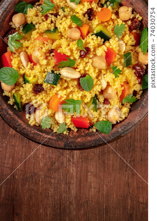 Couscous close-up in a tagine, top shot with copy space 74030754