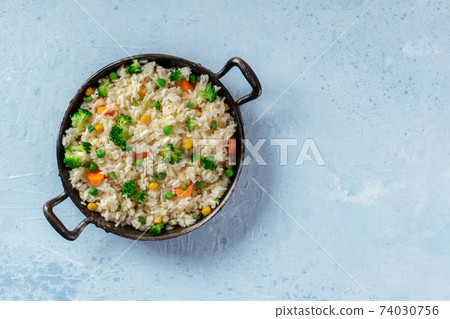 Vegan vegetable rice in a pan, top shot with copy space 74030756
