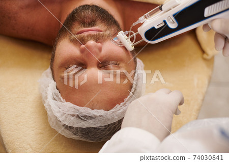 Mesotherapy, rejuvenation, anti aging treatment, prevention of the first wrinkles and signs of aging. Injection cosmetology. Mesotherapy gun 74030841