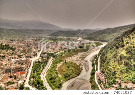 Panoramic aerial view to Berat old town and Osum river from Berat Castle , Albania Panoramic aerial view to Berat old town and Osum river from Berat Castle , Albania 74031027