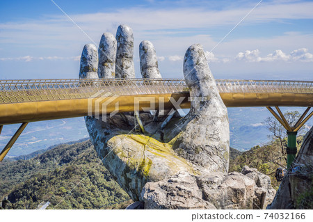 Famous tourist attraction - Golden bridge at the top of the Ba Na Hills, Vietnam Famous tourist attraction - Golden bridge at the top of the Ba Na Hills, Vietnam 74032166