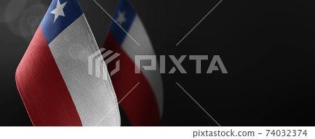 Small national flags of the Chile on a dark background 74032374