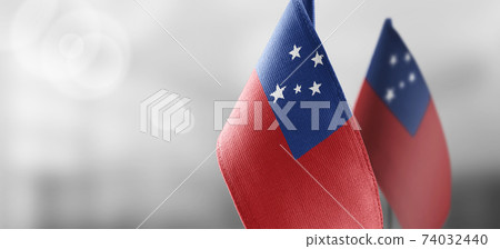 Small national flags of the Samoa on a light blurry background Small national flags of the Samoa on a light blurry background 74032440