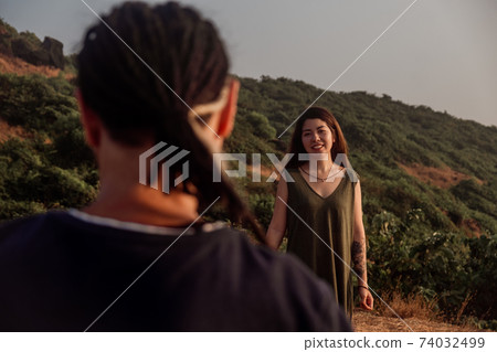 Guy, look at the woman at sunset Guy, look at the woman at sunset 74032499