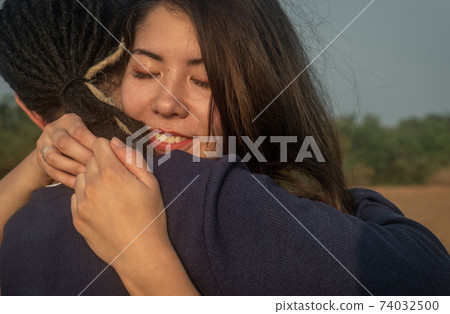 Young Couple Embrace Each Other Lovingly Young Couple Embrace Each Other Lovingly 74032500