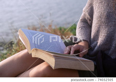Young Woman Reading Book close-up 74032505