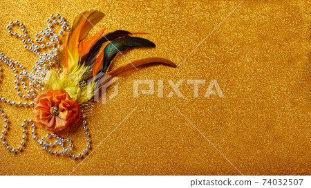 Festive, colorful Mardi Gras or carnivale mask on golden background. Venetian masks. 74032507