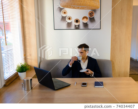 Young man on the street and in cafe with mobile phone, computer. 74034407