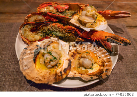 Delicious grilled lobster and scallops in seafood restaurant Delicious grilled lobster and scallops in seafood restaurant 74035008