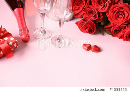 Valentine's day gift, hearts chocolate sweets, champagne and red roses. Greeting card with copy space. Close up. Valentine's day gift, hearts chocolate sweets, champagne and red roses. Greeting card with copy space. Close up. 74035333