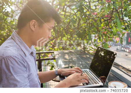 Asian man working on laptop Asian man working on laptop 74035720