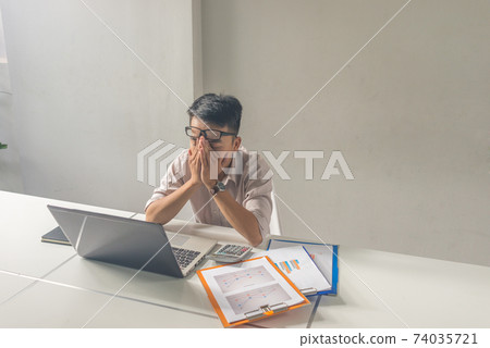 Young office man close eyes, feel headache, tired and exhausted Young office man close eyes, feel headache, tired and exhausted 74035721