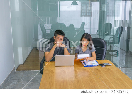 Business people discuss about financial document Business people discuss about financial document 74035722