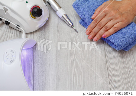 A set of cosmetic tools on a gray wooden background. A set of cosmetic tools on a gray wooden background. 74036071
