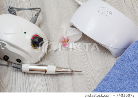 Set of cosmetic tools on a gray wooden background. 74036072