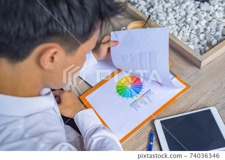 Asian businessman reading financial report in the office 74036346