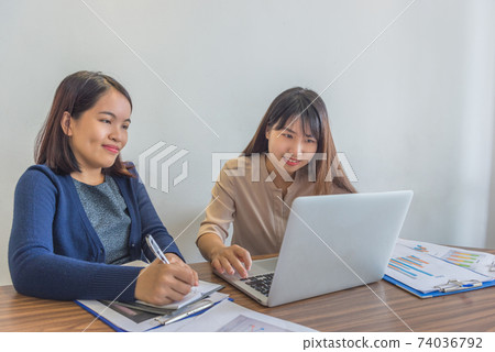 Asian female financial advisors using laptop and having business discussion Asian female financial advisors using laptop and having business discussion 74036792