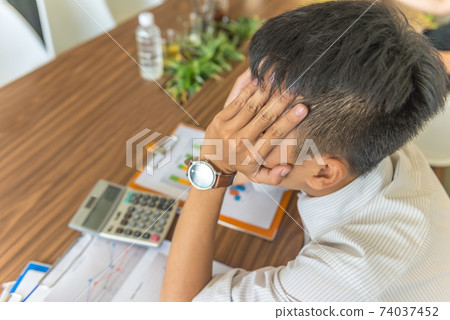 Young man worried about financial problem Young man worried about financial problem 74037452