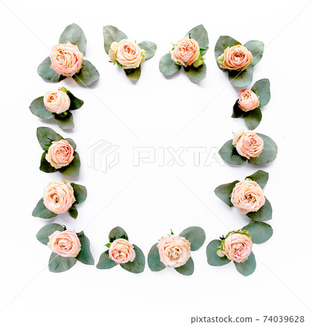 frame made of pink roses, green leaves eucalyptus, branches, floral pattern on white background. Flat lay, top view. Valentine's background.  74039628