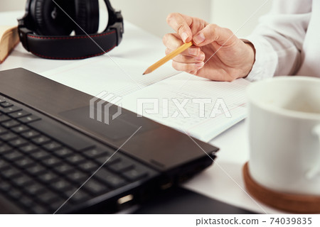 Remote work. Woman makes notes in notebook and using laptop for study. Distance education and e learning concept 74039835