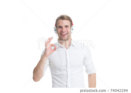 Man listening favourite song in headphones and singing.  74042294
