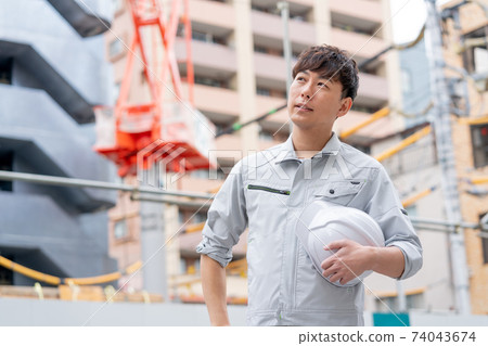 Young workers working at a construction site 74043674