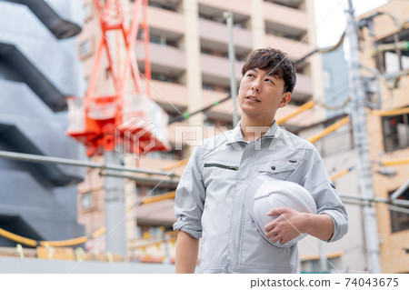 Young workers working at a construction site Young workers working at a construction site 74043675