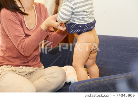 Changing baby diapers while standing 74043909
