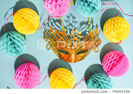 Carnival mask and confetti on a blue background. The concept of a traditional venetian carnival in 74044186
