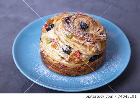 Craffin (Cruffin) with raisins, nuts and candied fruits. Easter Bread Kulich. Easter Holiday. Close-up. Craffin (Cruffin) with raisins, nuts and candied fruits. Easter Bread Kulich. Easter Holiday. Close-up. 74045191