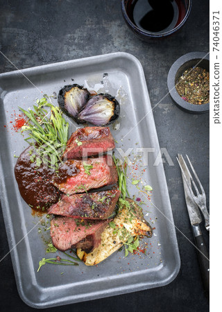 Italian barbecue dry aged sliced chateaubriand with mushroom  74046371