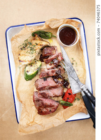 barbecue sliced rostbraten with fried mushrooms and paprika  74046375