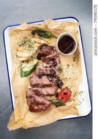 barbecue sliced rostbraten with fried mushrooms and paprika  74046376