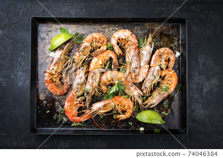 Traditional fried black tiger prawn with vegetable and lemon Traditional fried black tiger prawn with vegetable and lemon 74046384