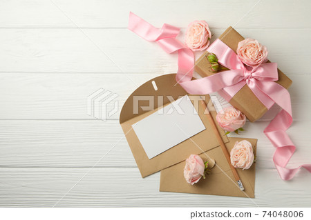 8 march concept with gift box and envelopes on white wooden background, space for text 8 march concept with gift box and envelopes on white wooden background, space for text 74048006