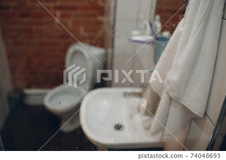 Blurred background flush toilet in bathroom at apartments 74048693