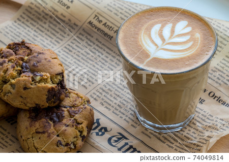 Coffee Latte Art. The coffee arts. Hot coffee in a white cup on wooden table. Coffee Latte Art. The coffee arts. Hot coffee in a white cup on wooden table. 74049814