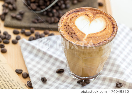 Coffee Latte Art. The coffee arts. Hot coffee in a white cup on wooden table. Coffee Latte Art. The coffee arts. Hot coffee in a white cup on wooden table. 74049820